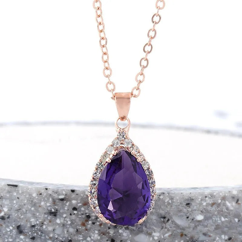 Women's alloy water drop necklace with rose gold electroplated colour and rhinestone inlays on a geometric pendant.