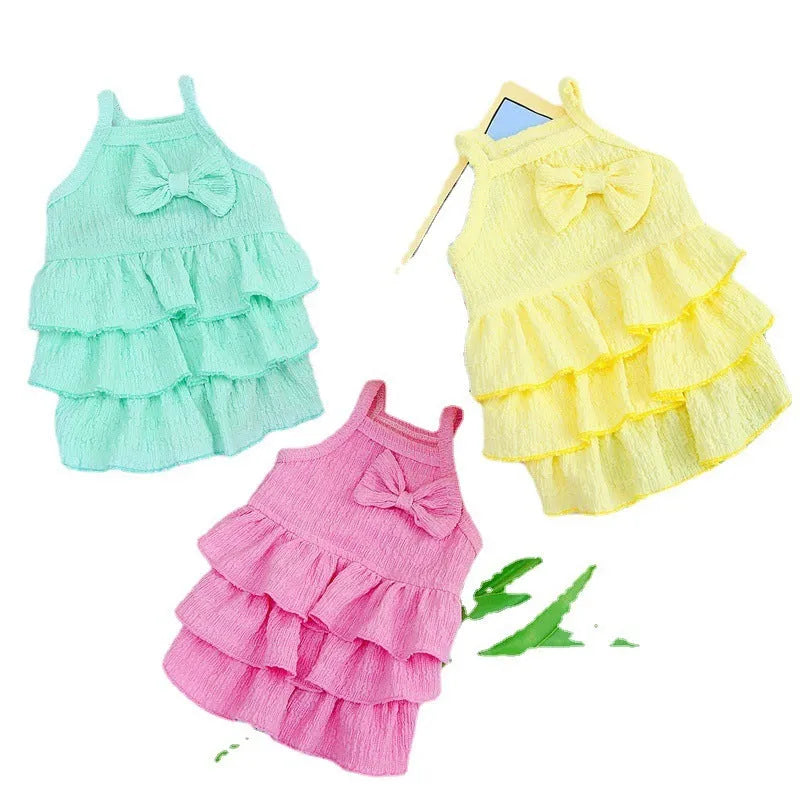 Small dog wearing princess dress with candy layered skirt in rose red, yellow, or water green