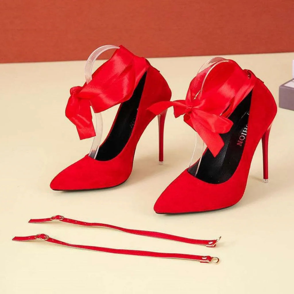 Women's black stiletto heels with thin ankle strap and pointed toe design