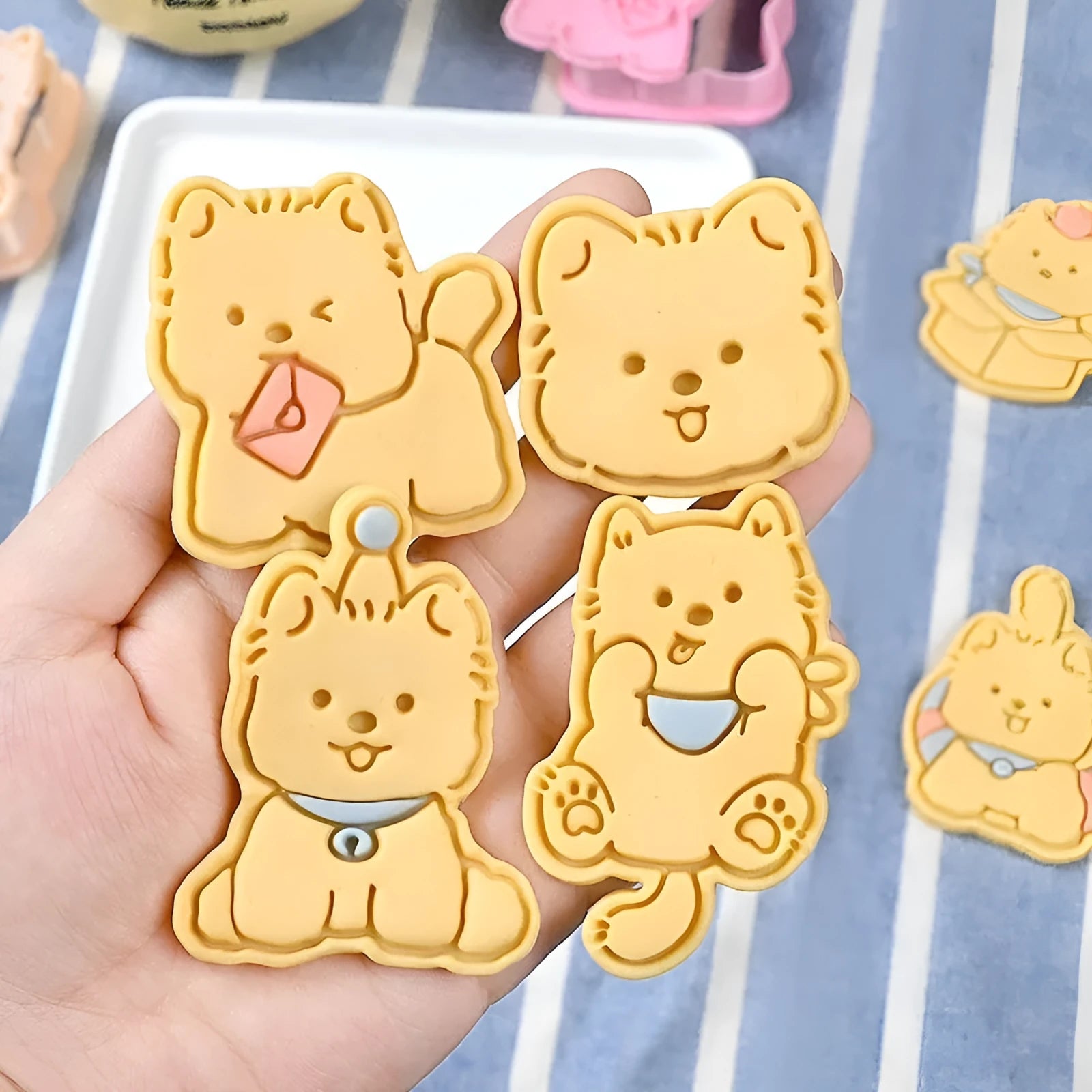 Plastic biscuit mould with puppy cartoon designs including birthday hats and swimming rings