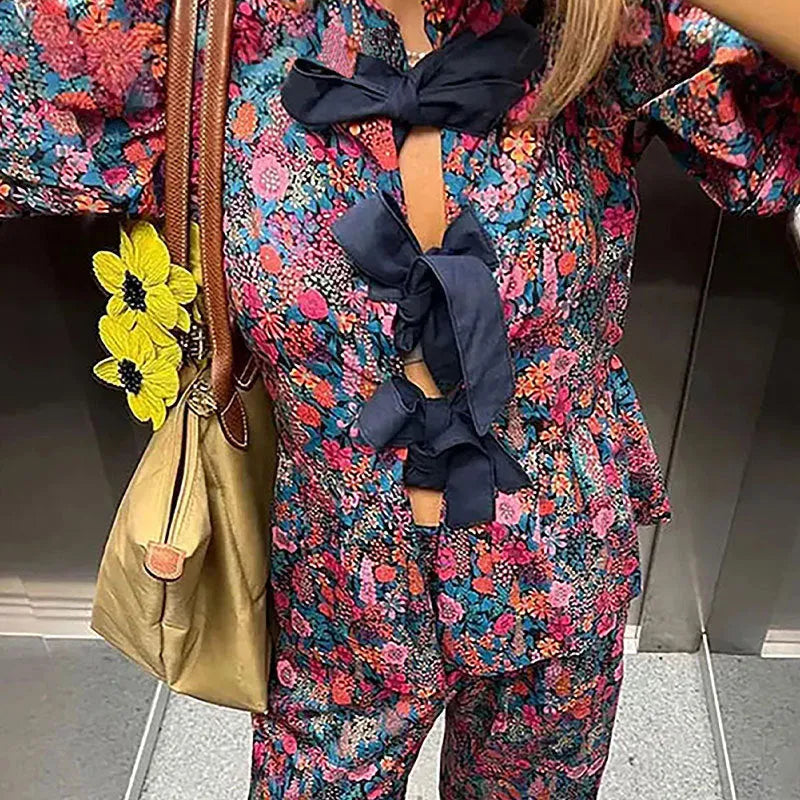 Floral printed tie-neck blouse and trousers suit set with puff sleeves.