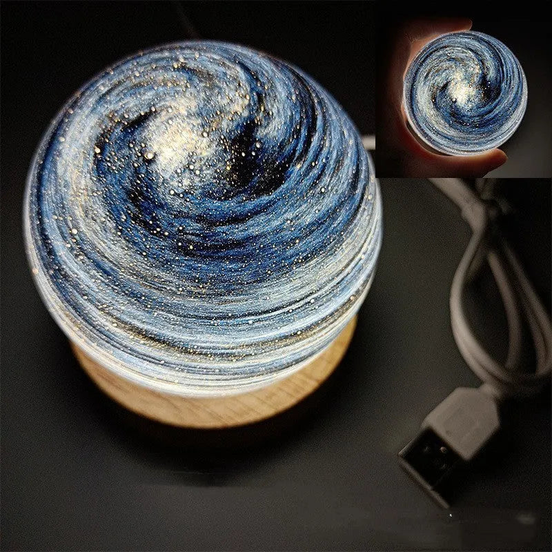 Spherical planet night light with USB cable, showing modern design and soft LED glow.