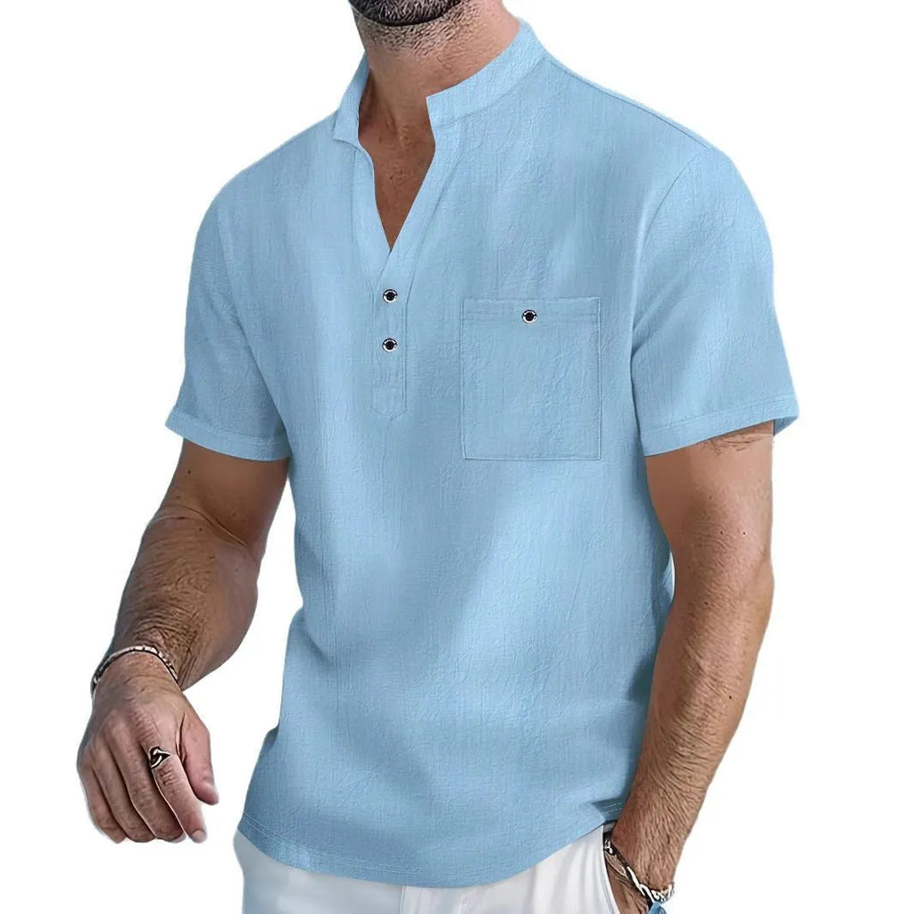 Man wearing a light apricot-coloured linen blend T-shirt with a stand collar and short sleeves.