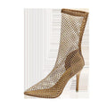 Gold high heel sandals with mesh upper, pointed stiletto toe, and an oversleeve design.