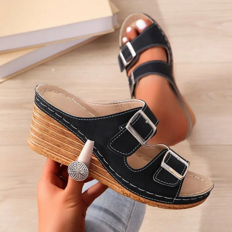 Women's creamy-white wedge buckle slippers with PU upper and rubber sole on a plain background.