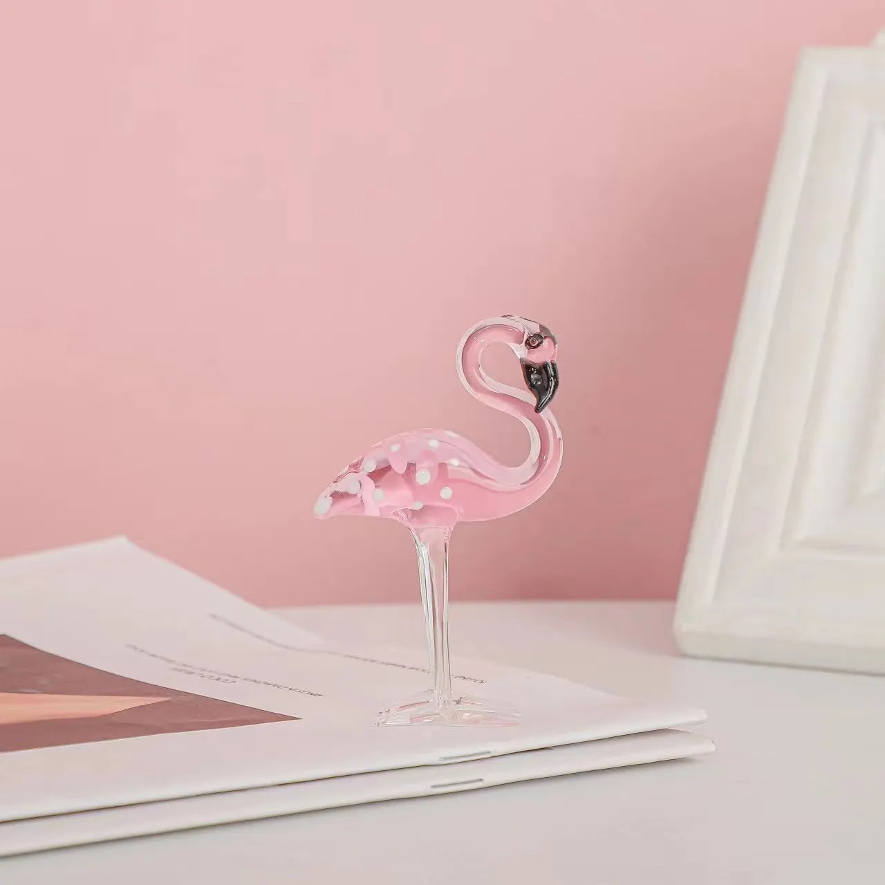 Pink crystal flamingo decorative animal figure on table with modern minimalist style
