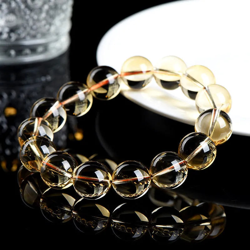 Original design natural citrine scattered beads ball bracelet showing polished yellow stones.