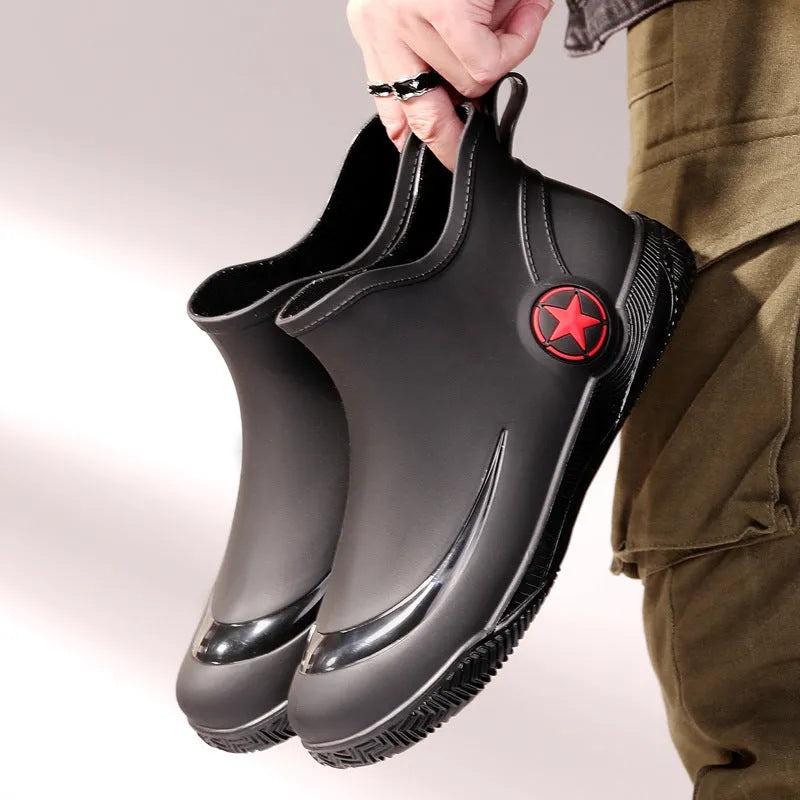 Unisex low-cut PVC rain boots in black with round toe and moulded plastic sole