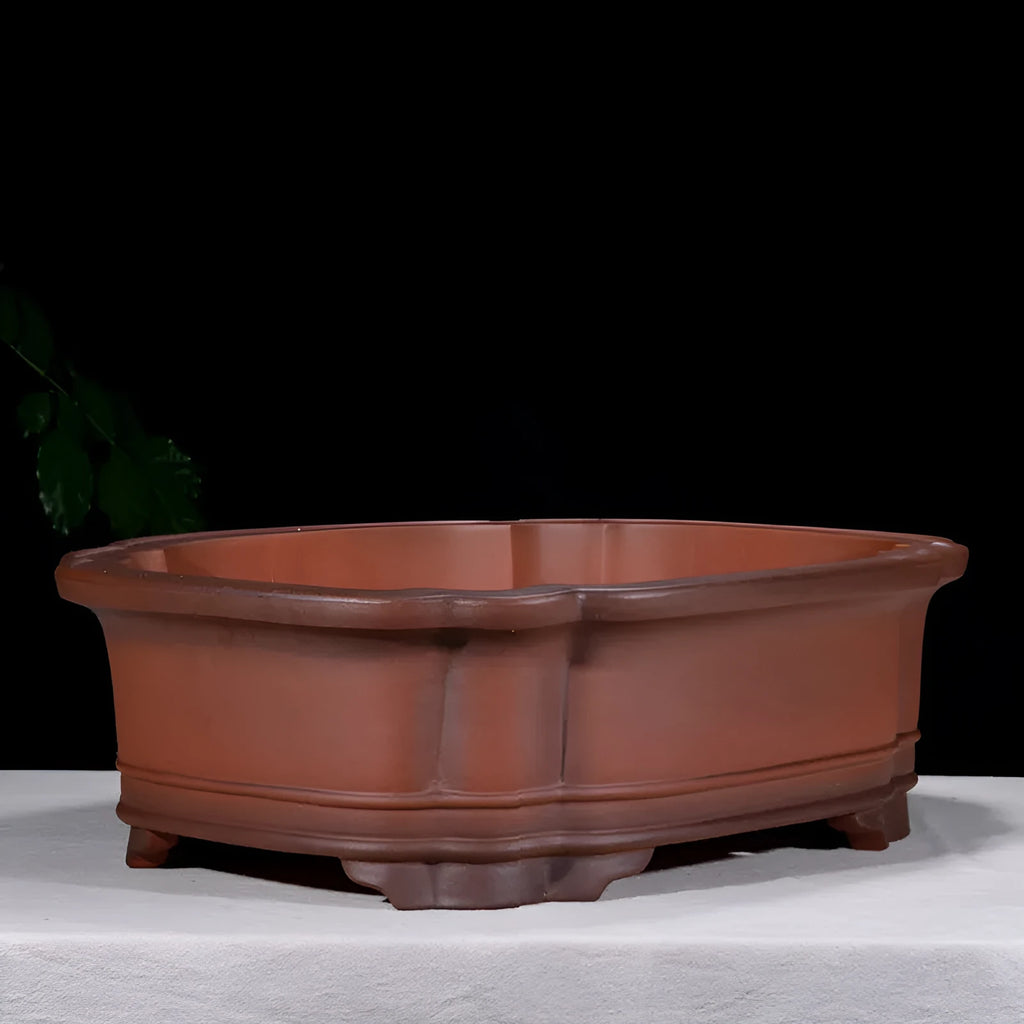 Large antique-style purple clay Chinese flower pot showing wide, shallow shape.
