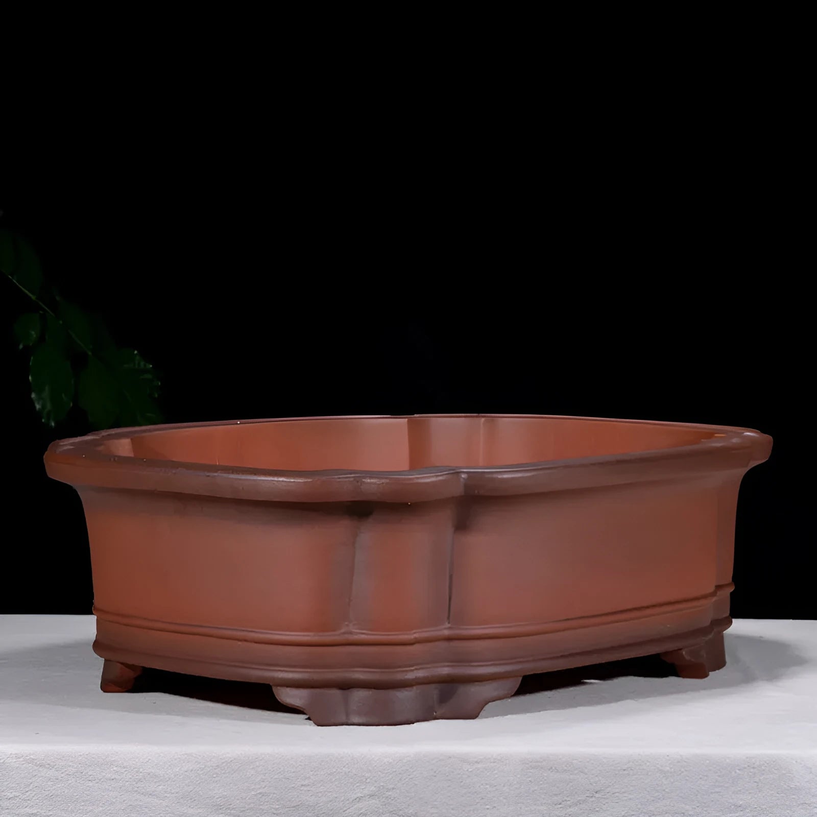 Large antique-style purple clay Chinese flower pot showing wide, shallow shape.