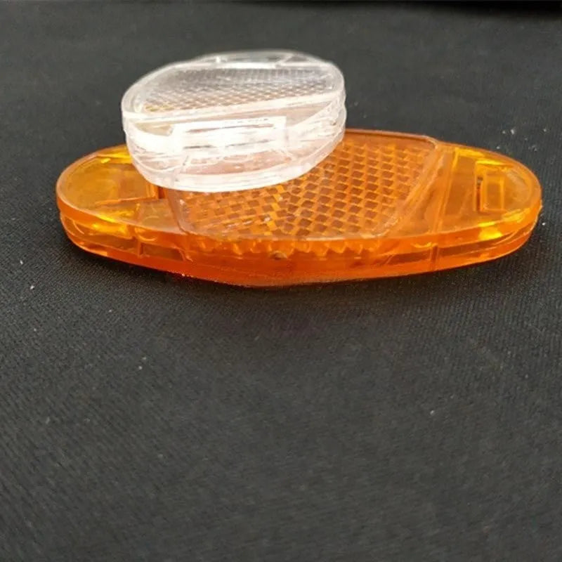 White and yellow plastic bicycle spoke reflectors with reflective warning film