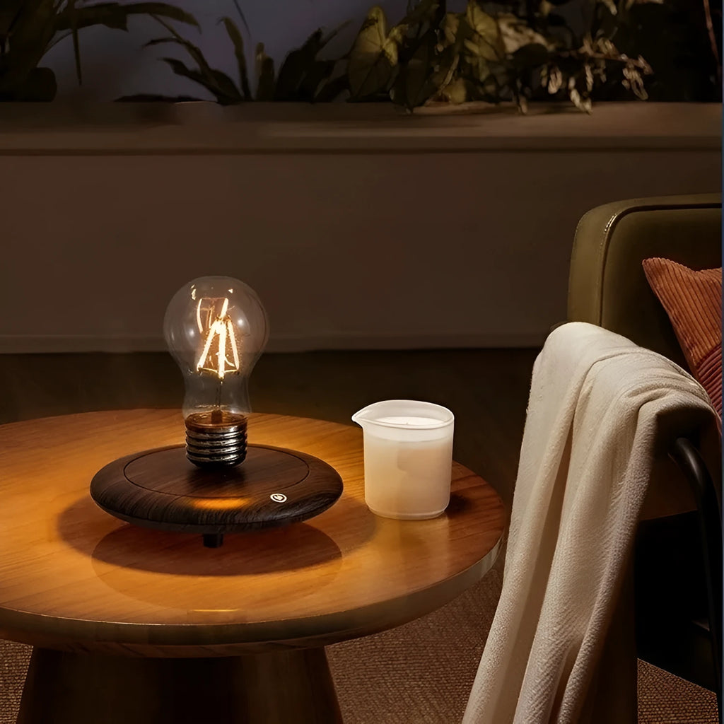Creative iron art suspension bulb night lamp on a black wood grain desktop base.