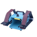 Blue desktop dual-axis belt sander with 750W motor and knife sharpener accessory on workbench