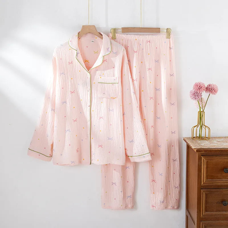 Women's cotton pajamas set in pink with long sleeves and trousers on hanger