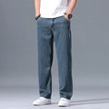 Men's light blue loose straight-leg lyocell jeans with a zipper fly on a neutral background.