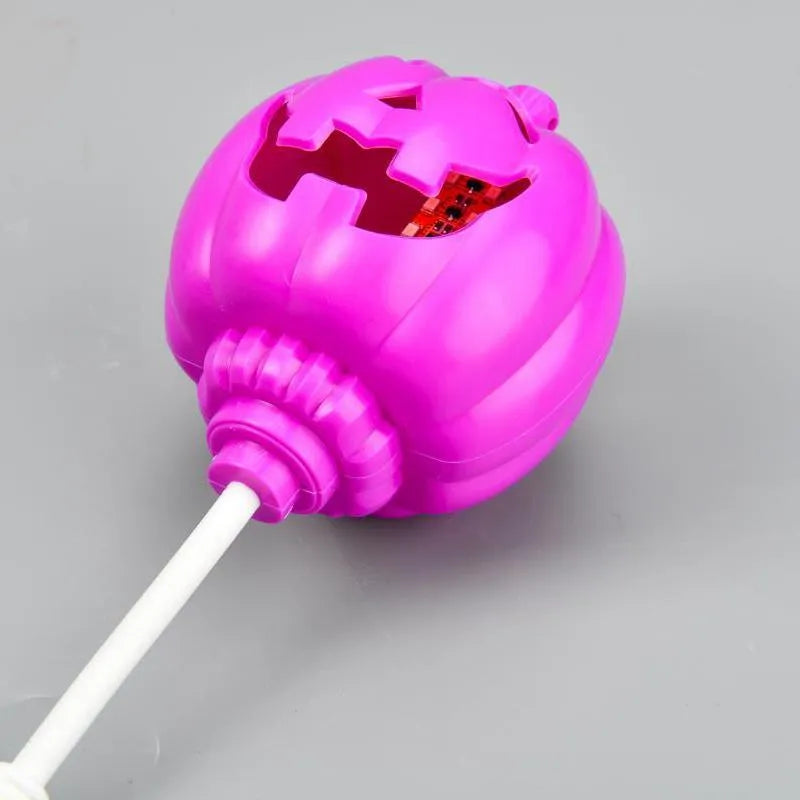 Plastic pumpkin-shaped decorative lamp with purple or yellow light, standing 22cm tall.