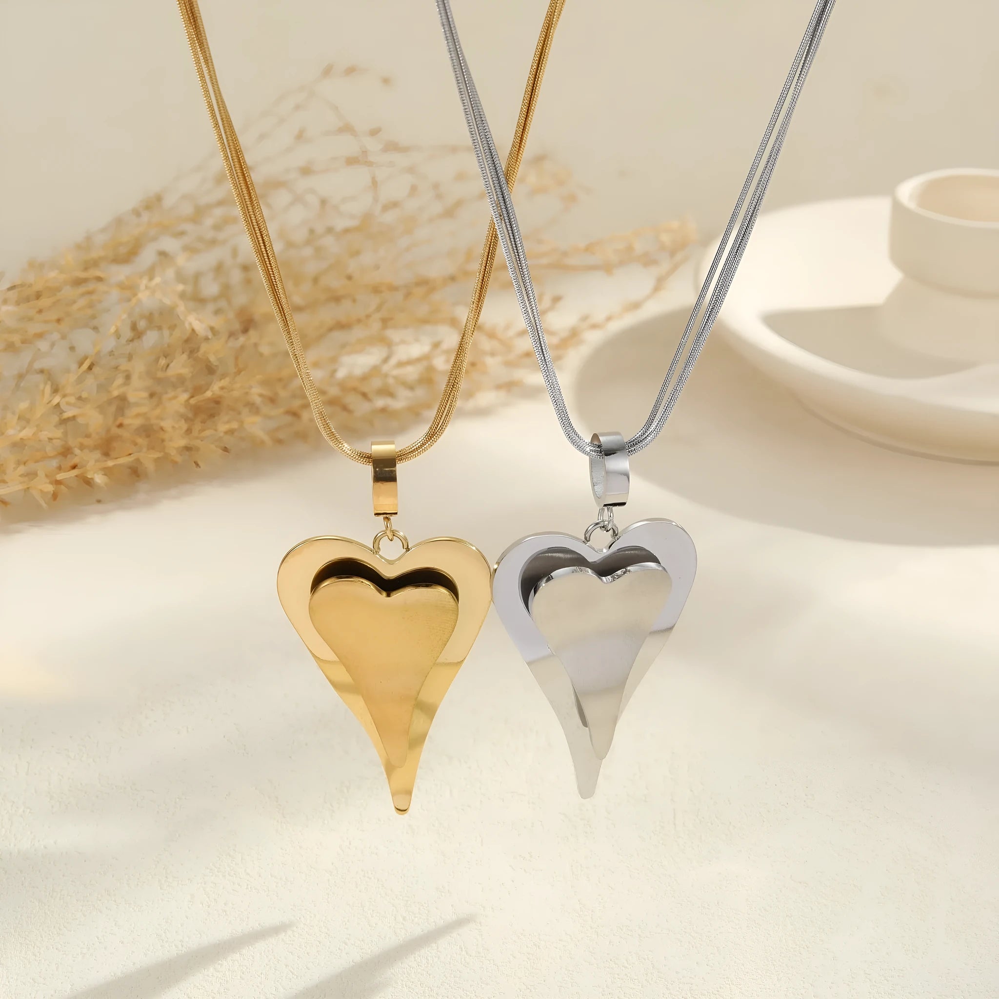 Geometric double heart pendant necklace with snake bones chain in gold or steel finish