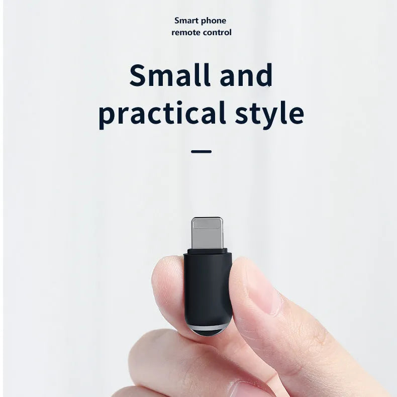 Small black capsule infrared remote control adapter for smartphone.