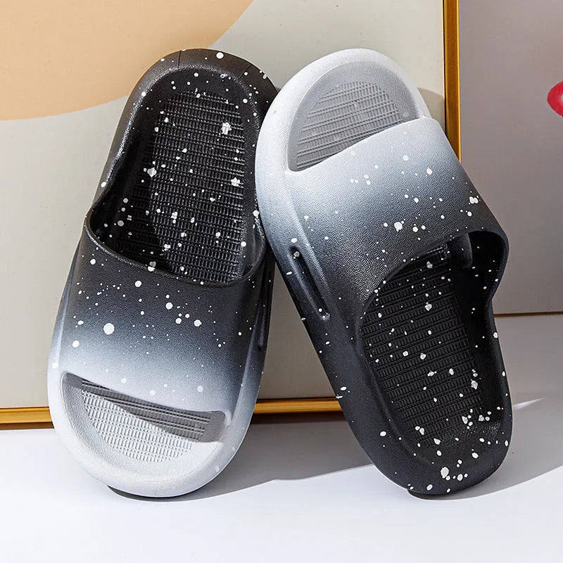Gradient blue children's PVC summer slippers with a non-slip sole on a wooden deck.