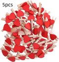 Five wooden heart-shaped hair clips in different colours on white background