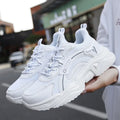 Women's white mesh casual sports shoes with a thick sole and a front buckle strap.