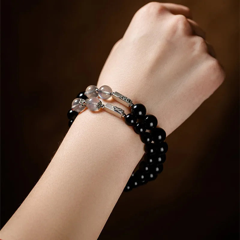 Obsidian Buddha beads couple bracelet set showing 10mm men's and 8mm women's Tibetan style bracelets