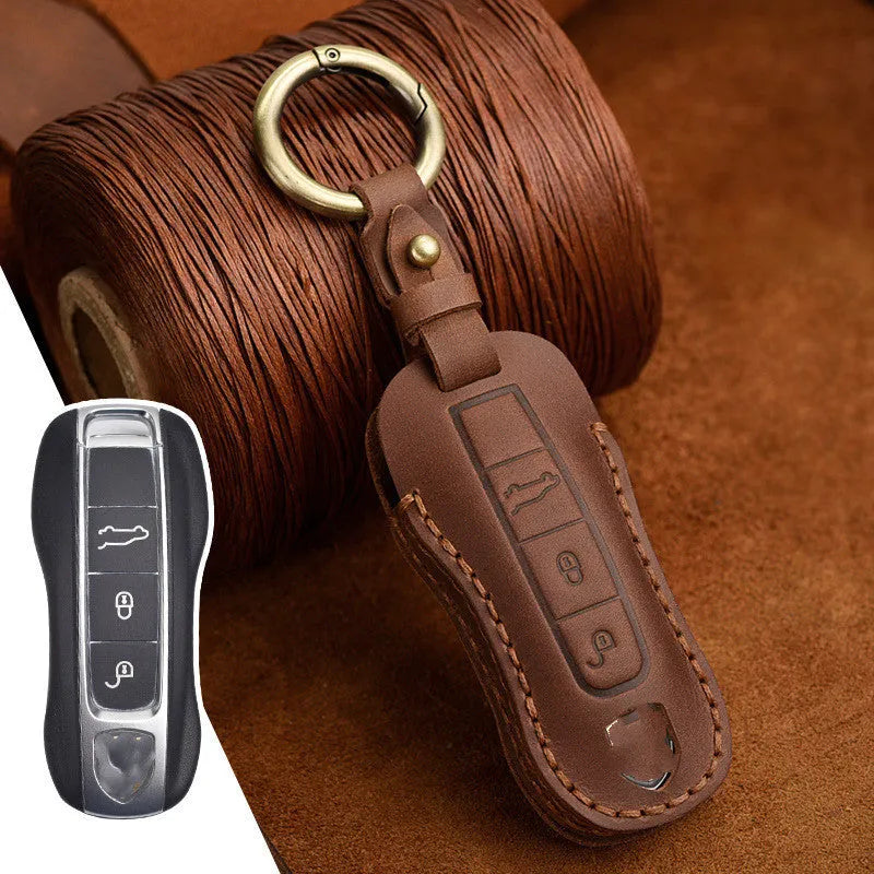 Brown leather Porsche key case with a metal buckle closure.