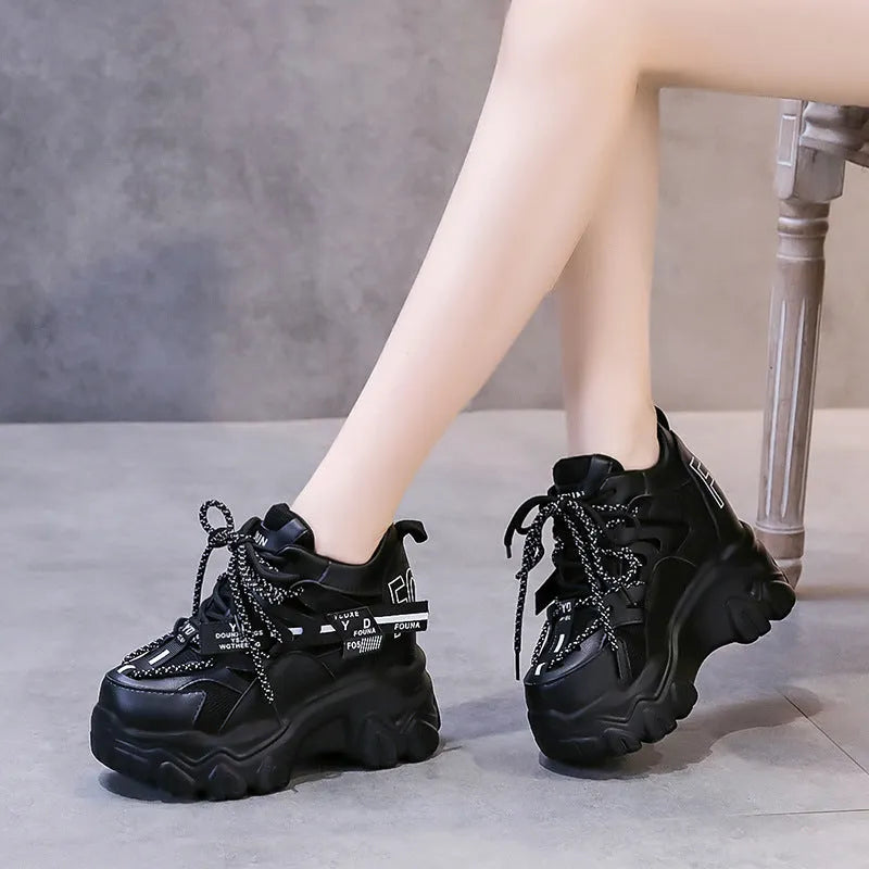 Women's white breathable mesh platform sports shoe with a cross strap on a rubber sole
