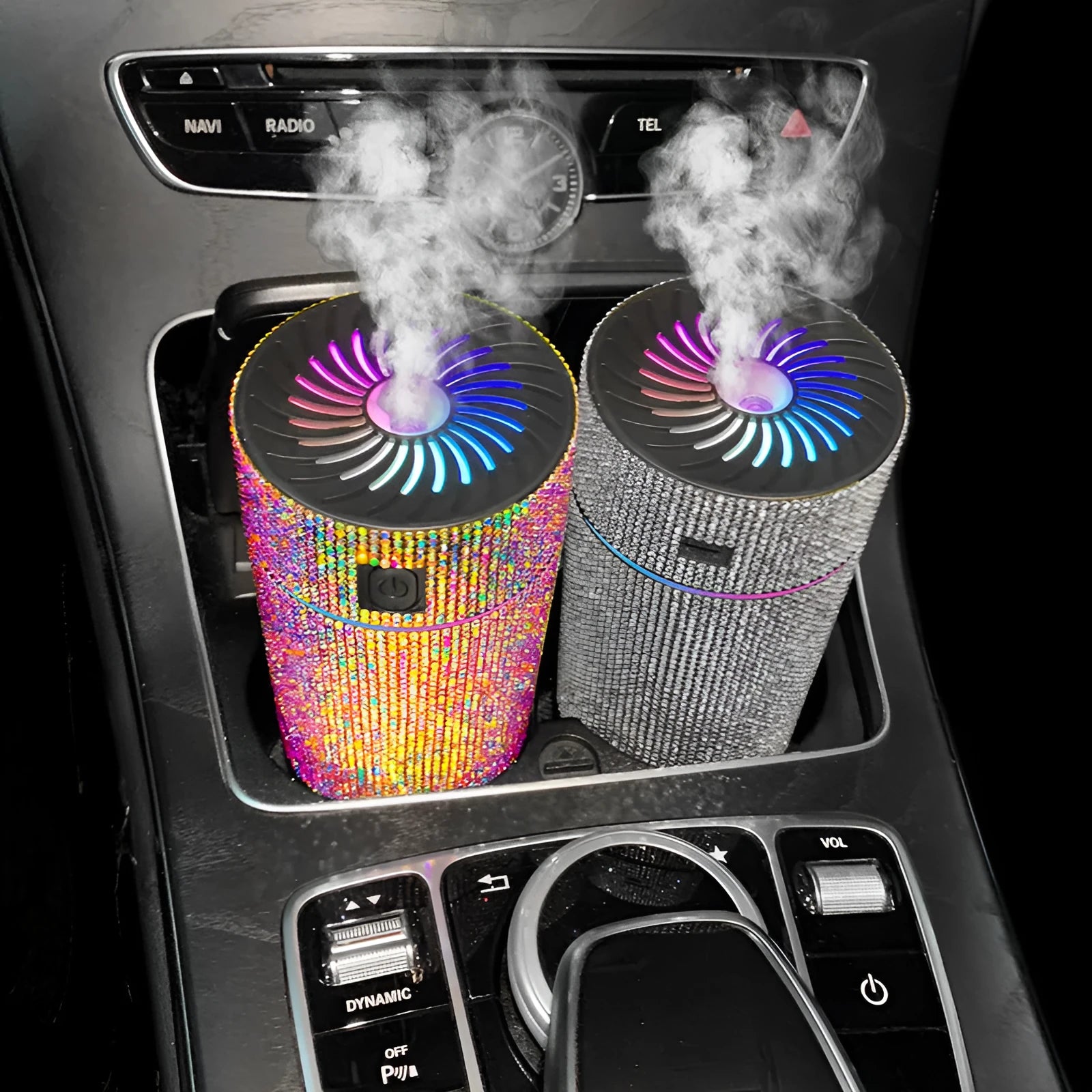 Compact white car air purifier and humidifier unit mounted on a car air vent.