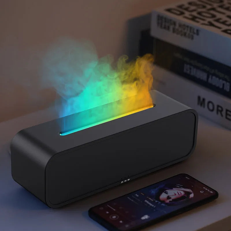 Black USB aroma diffuser with colour-changing LED lights and remote control on a wooden table.