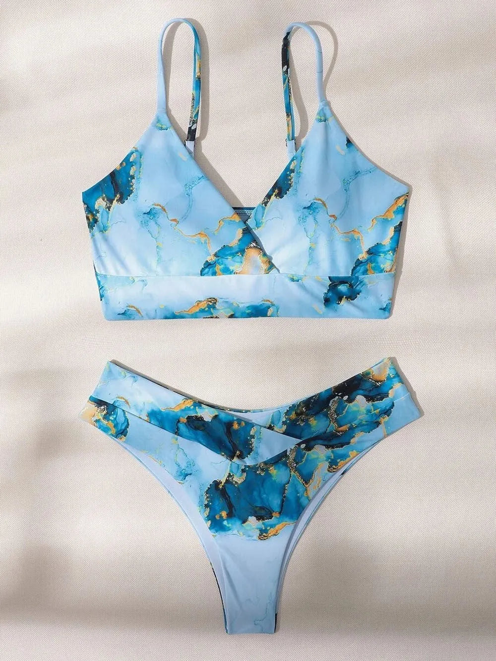 Women's marble print high-waist bikini set in blue tie-dye pattern for swimming.
