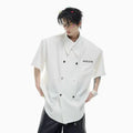 Men's loose fit short sleeve casual shirt with spliced panelling and metal button details.