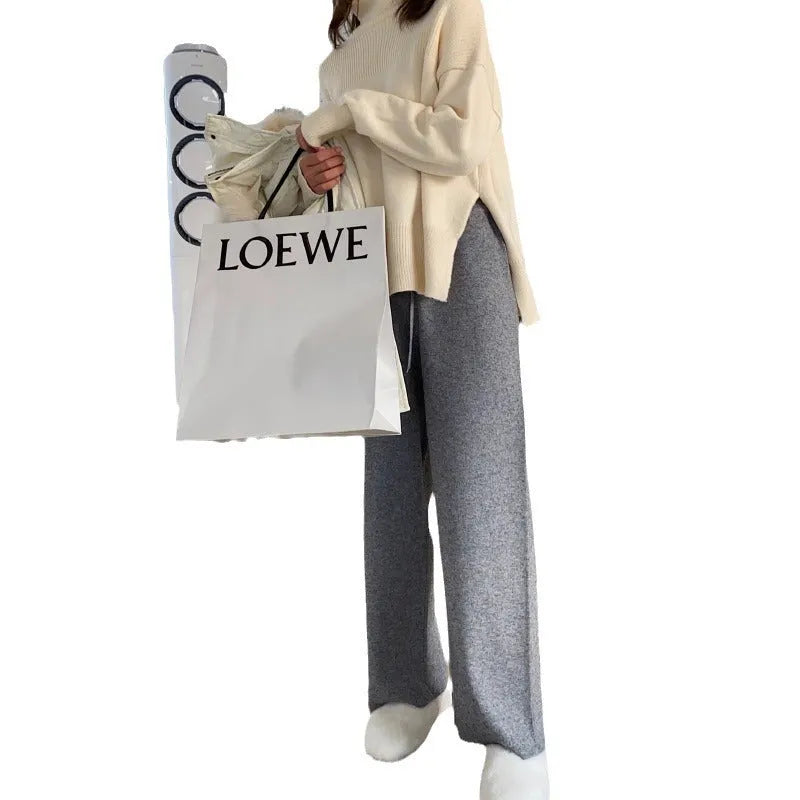 Women's cream white knitted wide-leg high-waist trousers laid flat, showing long straight-leg mopping style.