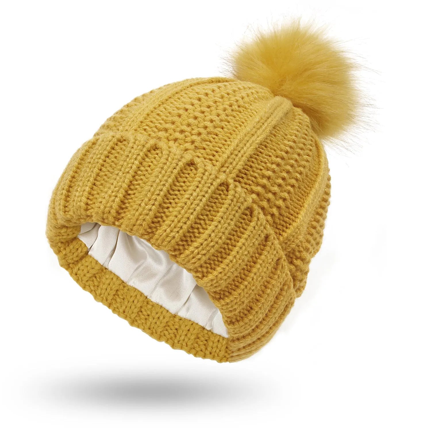 Women's knit beanie hat with faux fur pom pom and satin lining in various colours.