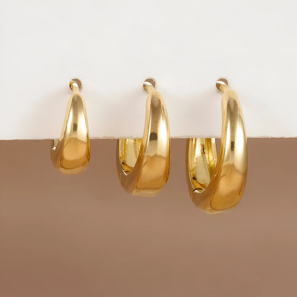 Three glossy geometric copper earrings set in gold electroplated finish