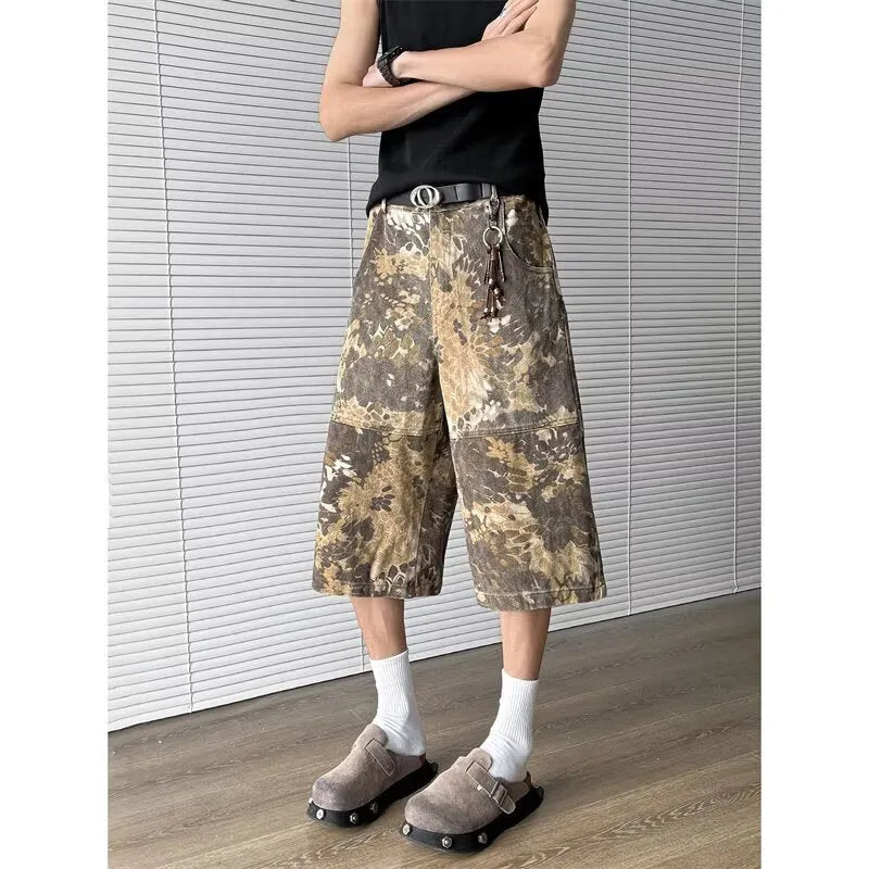 Yellow snake camouflage pattern on cropped denim jeans laid flat.