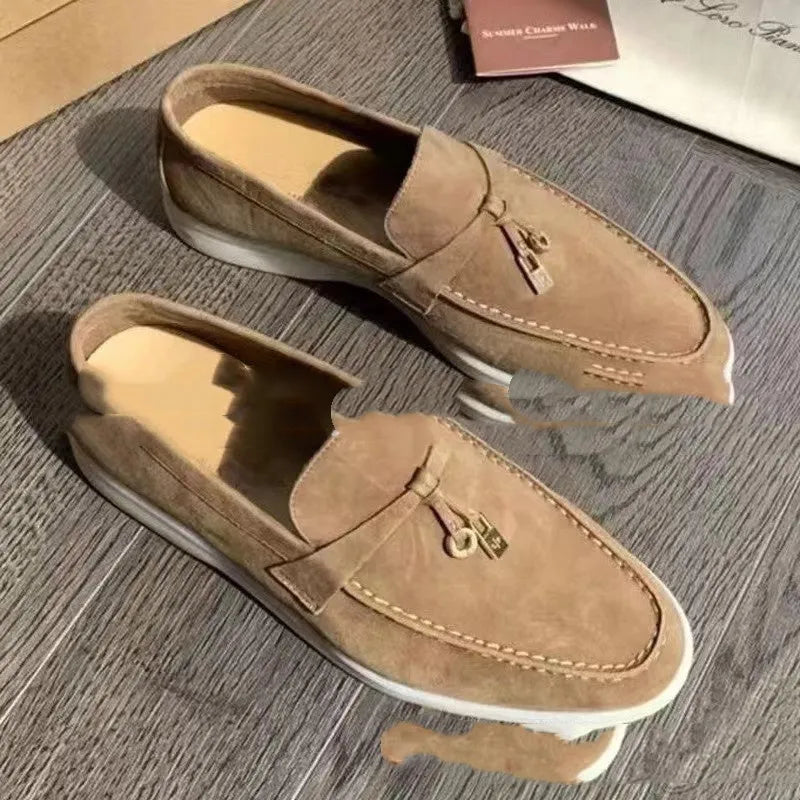 Casual slip-on Gommino loafers in black with round toe, rubber sole, and high-top design.