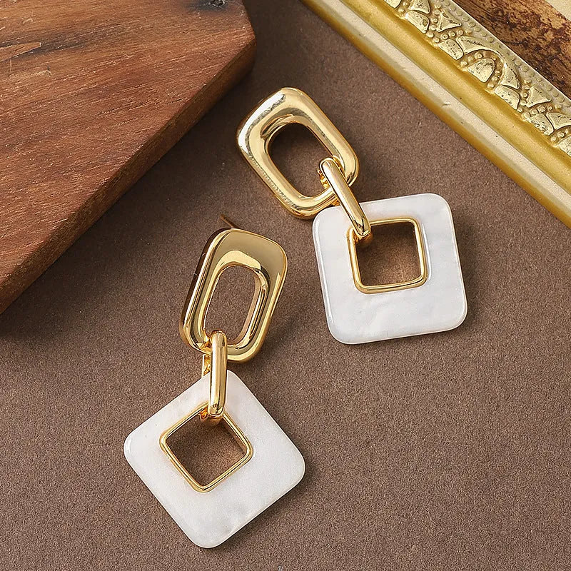 Geometric hollow square earrings with chamfered corners in electroplated copper
