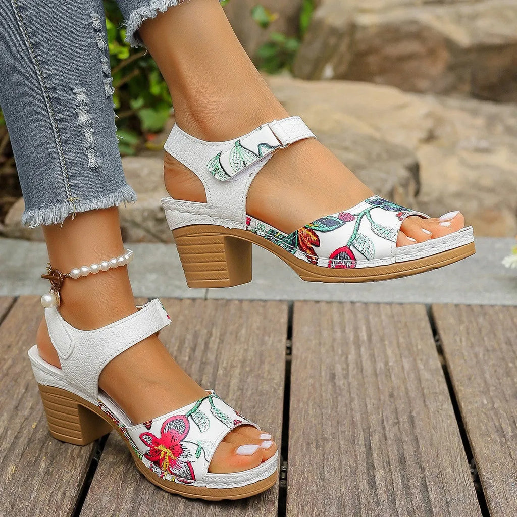 White women's high heel sandals with adjustable Velcro buckle strap on a rubber sole.