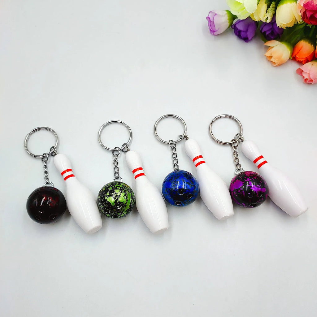 Mini bowling ball simulation keychain in blue, red, purple, and green colours.