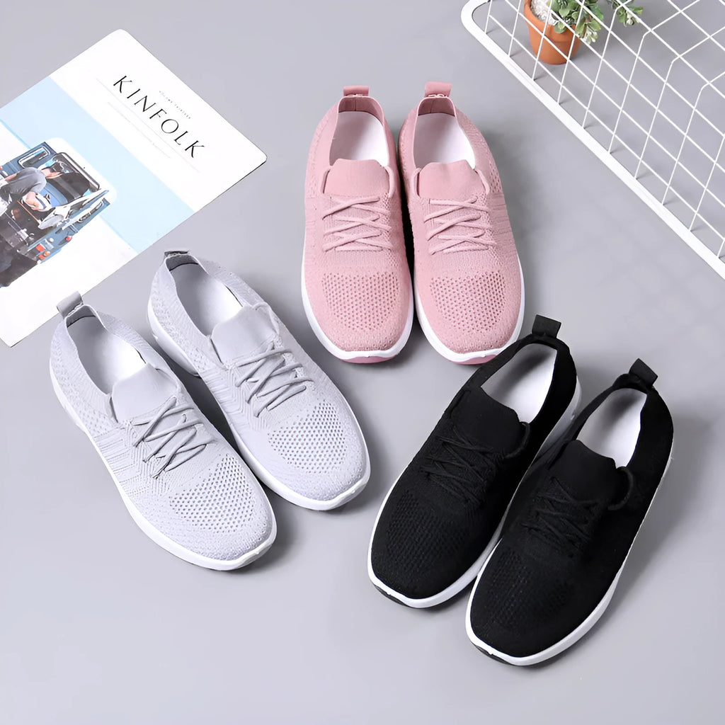 Women's black mesh casual sneaker with round toe, lace-up front, and a light-coloured soft sole.
