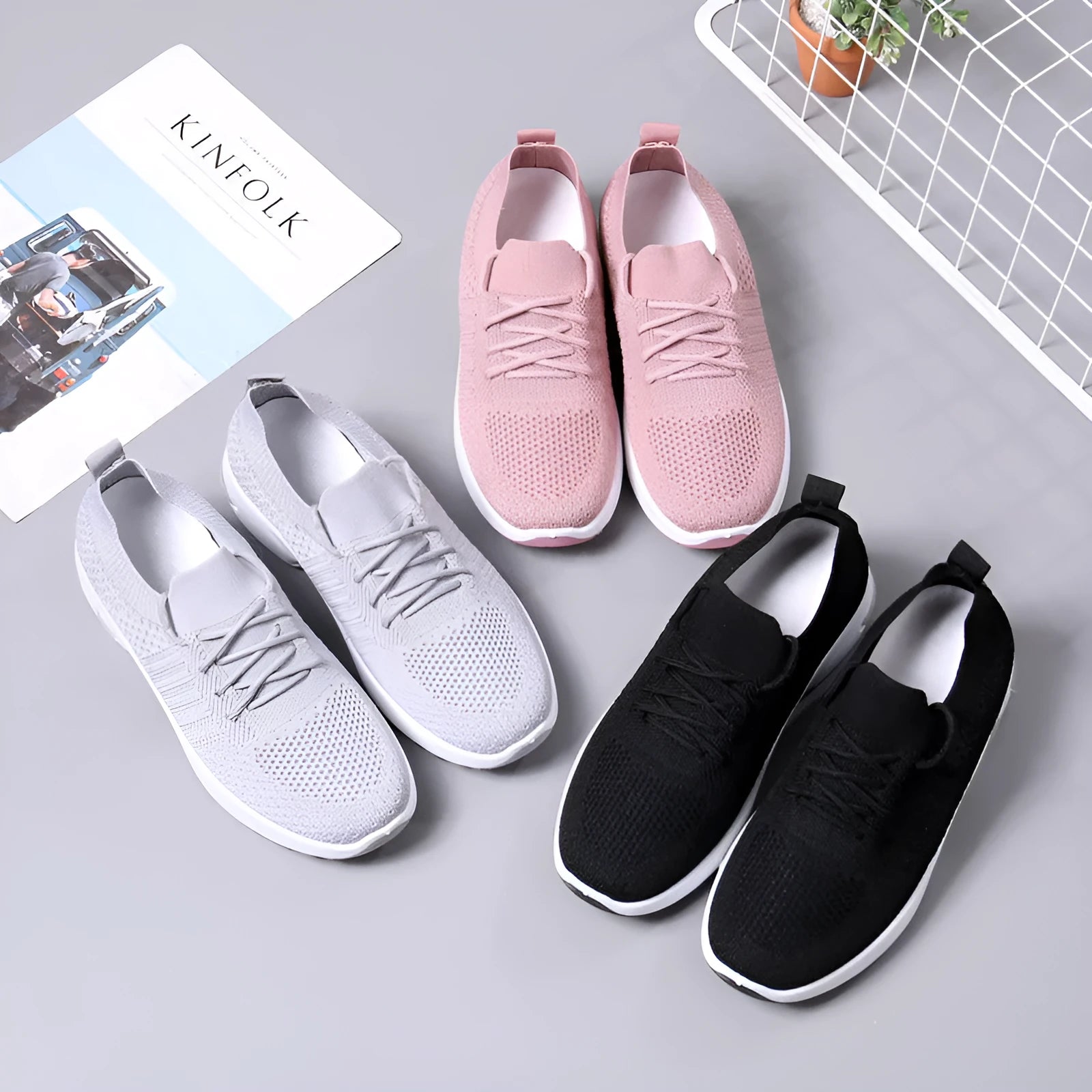 Women's black mesh casual sneaker with round toe, lace-up front, and a light-coloured soft sole.