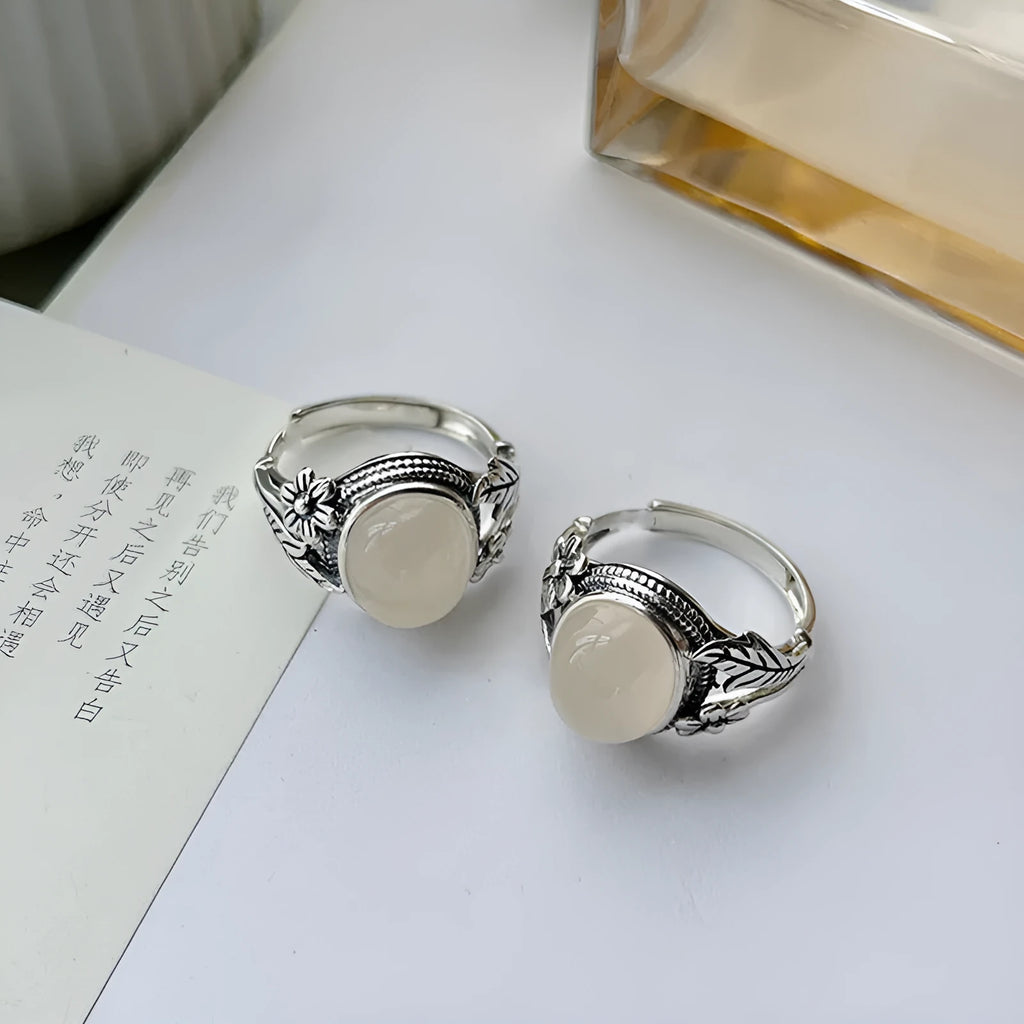 Adjustable copper vintage ring with imitation white chalcedony stone on a U-shaped band.
