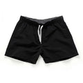 Men's straight-leg polyester beach shorts on a hanger, showing the classic fit and available in multiple solid colours.