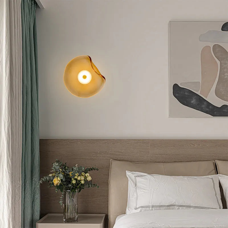 Round decorative wall lamp with glass shade in choice of cognac, light purple, or smoky grey finishes for bedroom lighting