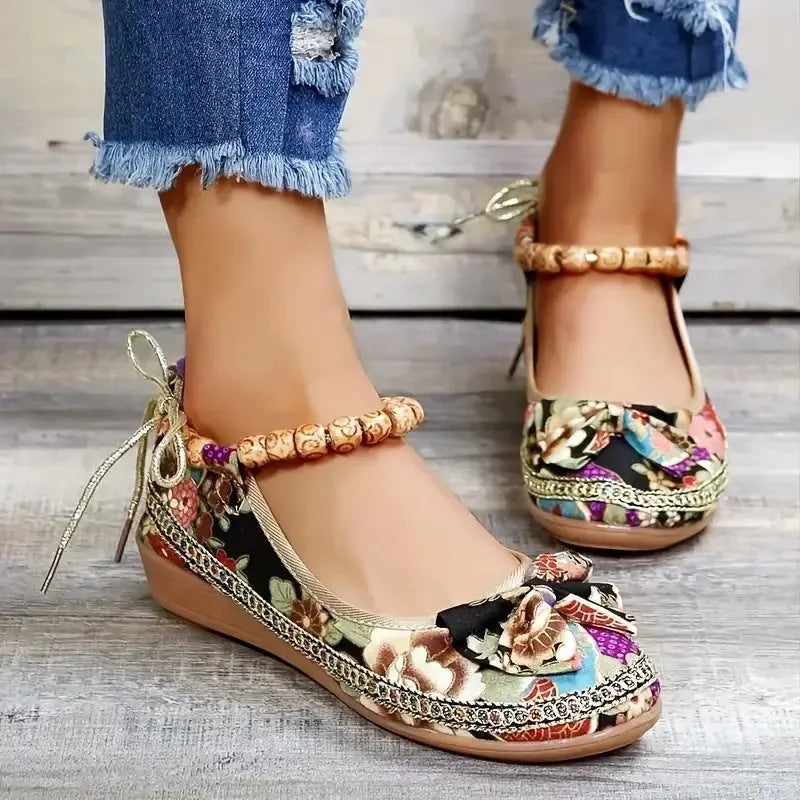 Women's black ethnic platform sandals with cloth upper and elastic band fastening on a white background.