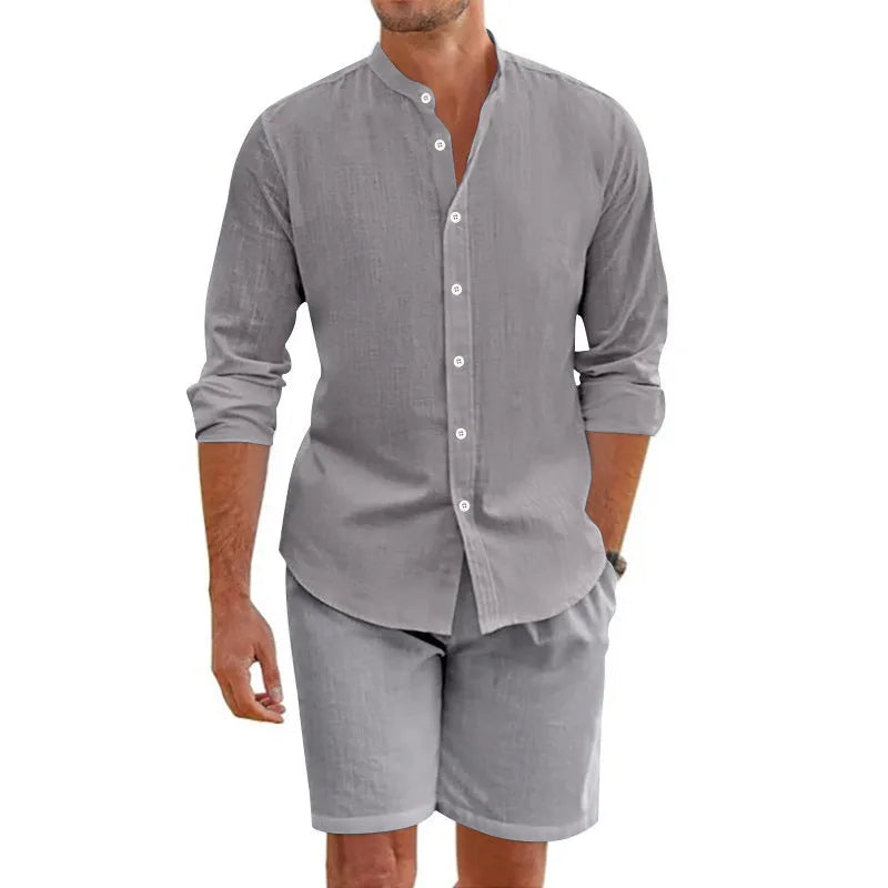 Man wearing a dark grey linen blend short sleeve shirt and matching drawstring shorts summer suit.
