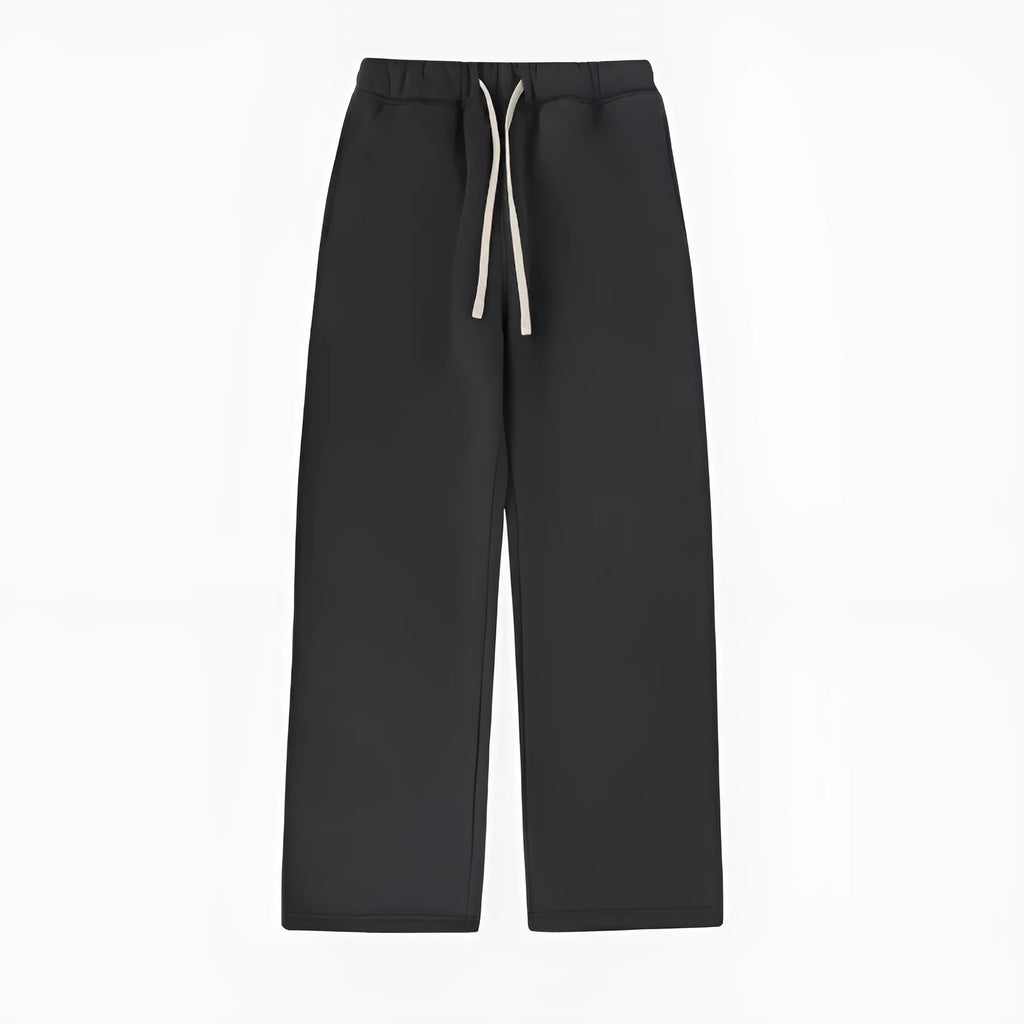 Man wearing loose fit grey fleece-lined sweatpants with an elastic drawstring waist.