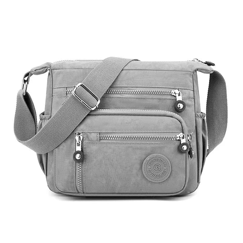 Nylon soft shoulder messenger bag in square vertical shape with single strap.
