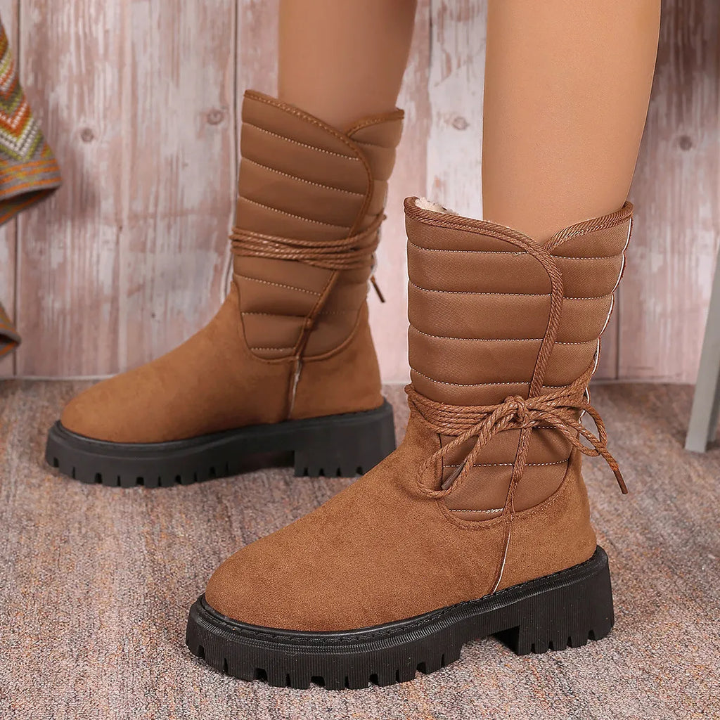 Women's black suede chunky heel snow boots with lace-up design and high top.